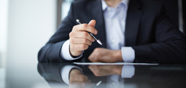 Close-up of male hands with pen