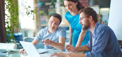 Group of three successful business partners in casual discussing