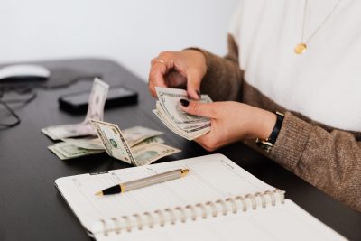 woman counting money at a desk