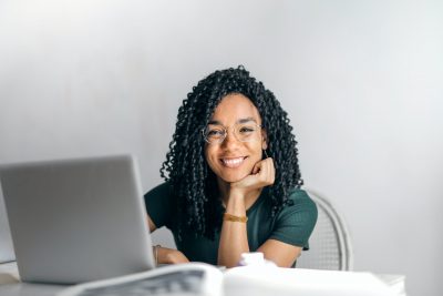Black female worker smiling about her work perks