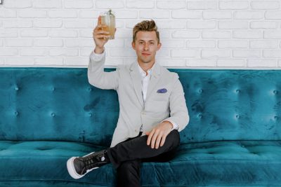 a man raising a glass to the camera